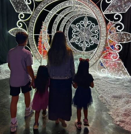 Family enjoying snow light display